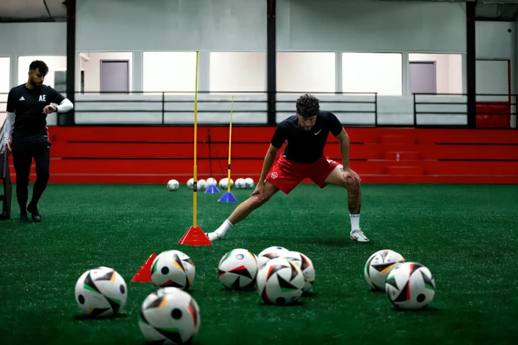 Coach training players on the field